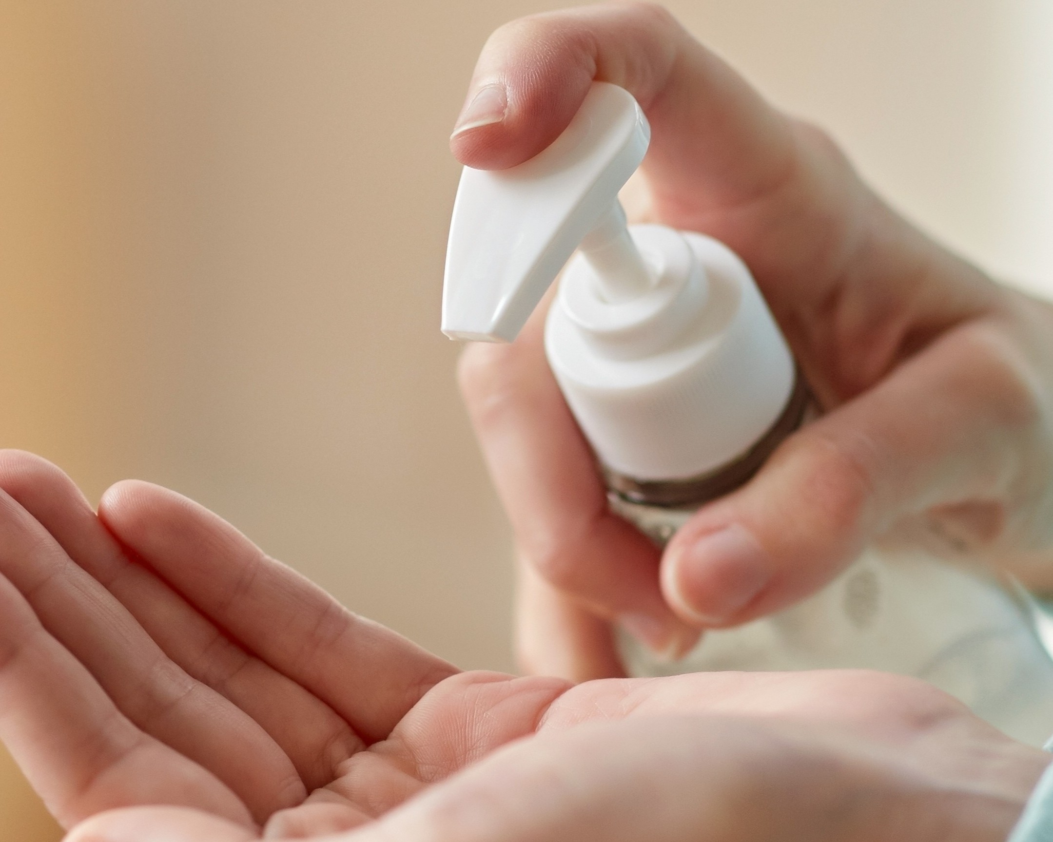 close up of woman applying hand sanitizer